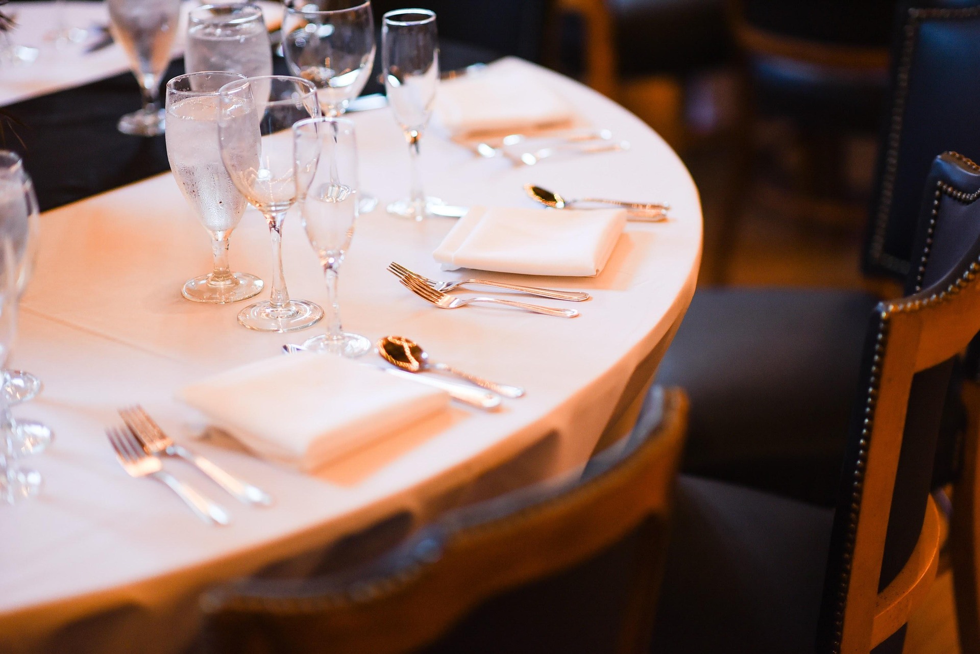 Close-up of a round fine dining table setting for a corporate event seating arrangement